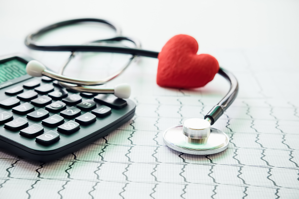 Calculator with stethoscope and a plush heart to show healthcare cpa services.