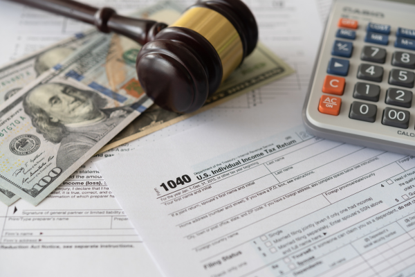 Tax accounting documents with a gavel and money.