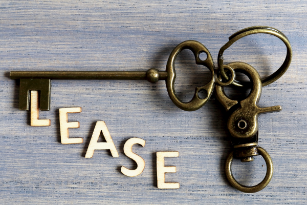 A golden key with the letters spelling lease