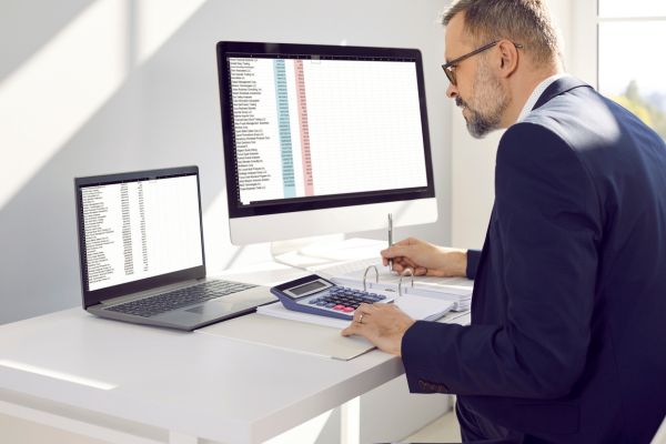 Businessman doing NetSuite transition on computer.